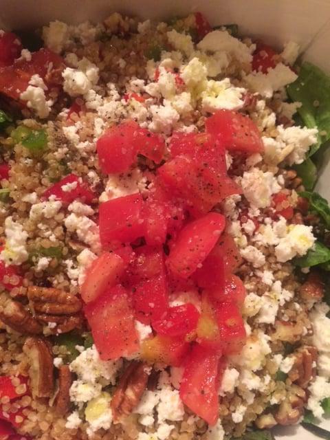 Quinoa Salad · Organic white quinoa mixed with bell peppers and crumbled feta cheese over red leaf lettuce garnished with tomato and walnuts, dressed with lemon juice and extra virgin olive oil. Gluten free. Vegetarian.