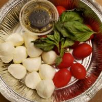 Caprese Salad · Grape tomatoes, fresh mozzarella balls and basil with extra virgin olive oil and balsamic vi...