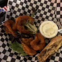 Buffalo Shrimp · Tossed in Buffalo sauce with a drizzle of blue cheese dressing.