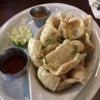 Chicharrones · Fried pork rinds served with Tapatio sauce and tomatillo salsa