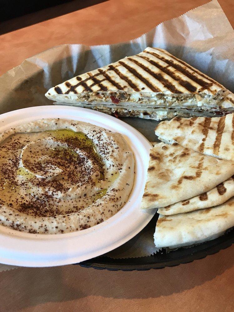 Chicken Zaki · #1 Item in Jasmin & Olivz! Over 300 sold daily... 
Jasmin chicken, sun-dried tomato, feta and mozzarella cheese and pesto sauce. Pressed and grilled to perfection. Zaki is a registered trademark by Jasmin & Olivz.