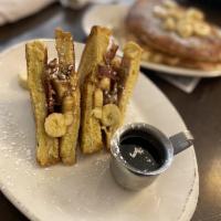 Elvis French Toast · French toast sandwich stuffed with peanut butter, chopped bacon, and banana.
