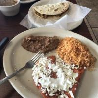 Enchiladas Potosinas · 4 enchiladas filled with fresh cheese and topped with sour cream, queso fresco and fresh oni...