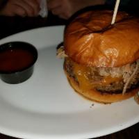 The Tar Heel Burger · House blend, cheddar, pulled pork shoulder, pickles, BBQ sauce and bank slaw.
