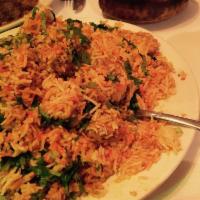 Biryani · Long grain basmati rice cooked with exotic herbs and spices, served with raita. 