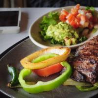Carne Asada · Grilled skirt steak marinated in our delicious pineapple, wine, soy sauce. Served with Guaca...