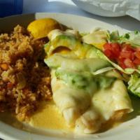 Seafood Enchiladas · 2 flour tortillas stuffed with shrimp, scallops, with delicious seafood sauce and melted che...
