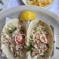Fried Fish Tacos · 2 soft flour tortillas with fried fish, jalapenos, cabbage, and chipotle sauce.