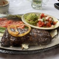 Beef Fajitas · Grilled marinated skirt served with Fresh Flour tortillas, Guacamole, Pico de Gallo, Mexican...