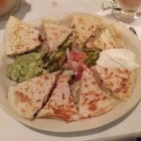 Chicken Quesadilla · Grilled chicken with melted cheese, guacamole, jalapeno, and sour cream.