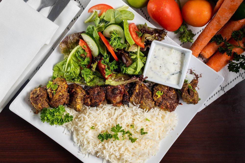 Chicken Kabob · Chicken breast cubes marinated with special spices and grilled. Served with rice, salad and pita bread.