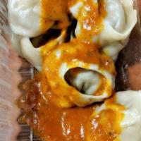 Chicken Momo · Steamed dumplings filled with minced chicken, onion, garlic, ginger and cilantro. Served wit...
