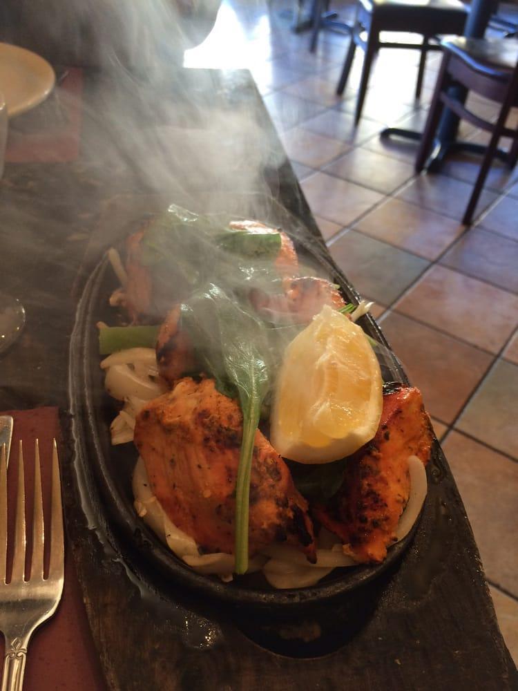 Chicken Tandoori · Bone in Chicken marinated in yogurt and spices, roasted in tandoor oven. Served in sizzling platter with sauteed onions, bell pepper, cabbage, carrot and spinach. Served  choice of side.