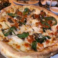 Goat Cheese Pizza · Mushrooms, garlic, spinach, red onion, pine nuts, roasted tomato. Vegetarian.