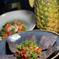 Tuna Tartare · Papaya, Asian dressing, burnt avocado, and blue corn chips 