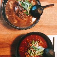 Spicy Beef Ramen · Oxtail bone marrow based spicy soup. Topped with marinated halal beef, scallions, bean sprou...