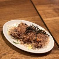 Takoyaki · Bits of octopus and dough topped with takoyaki sauce, mayo, and bonito flakes.