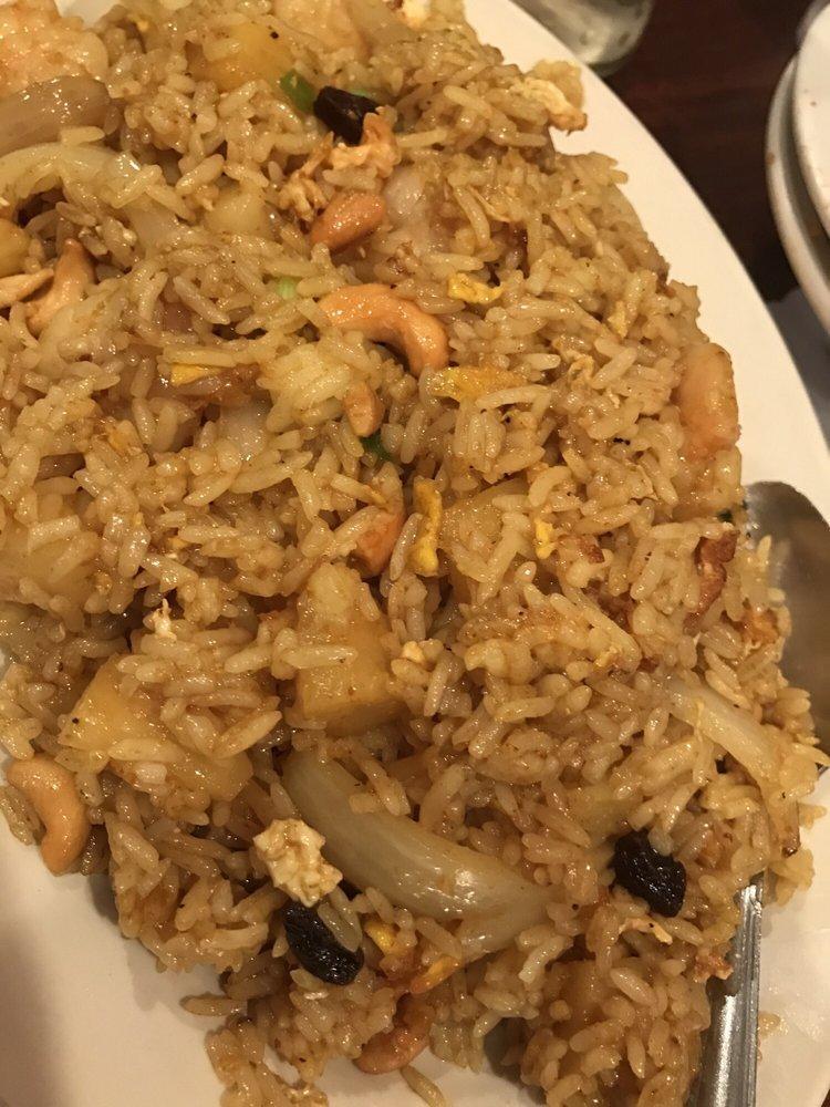 Pineapple Fried Rice · Choice of meat stir-fried with rice, pineapple, egg, onions, green onions, cashews, and raisins in yellow curry powder.