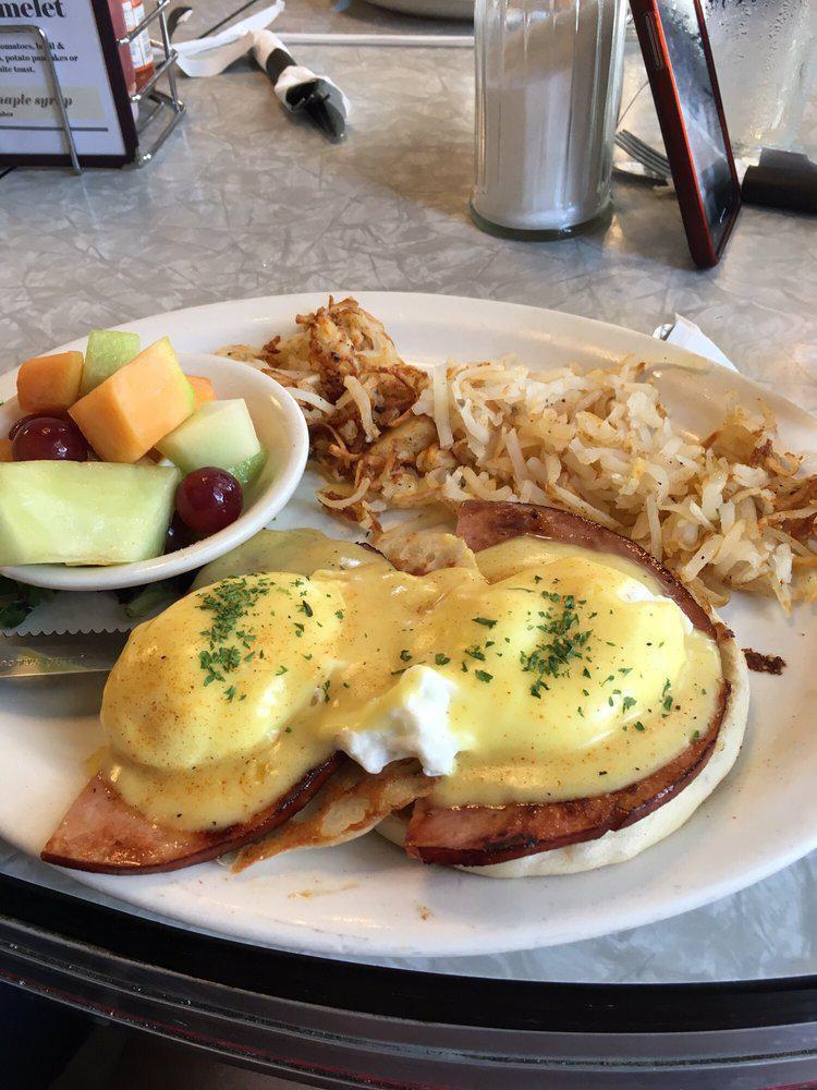Eggs Benedict · 2 poached eggs and Canadian bacon on an English muffin smothered with hollandaise sauce and served with your choice of potato.