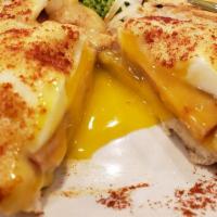 Eggs Benedict · English Muffin, seared Canadian bacon, poached eggs and home-made Hollandaise; accompanied w...