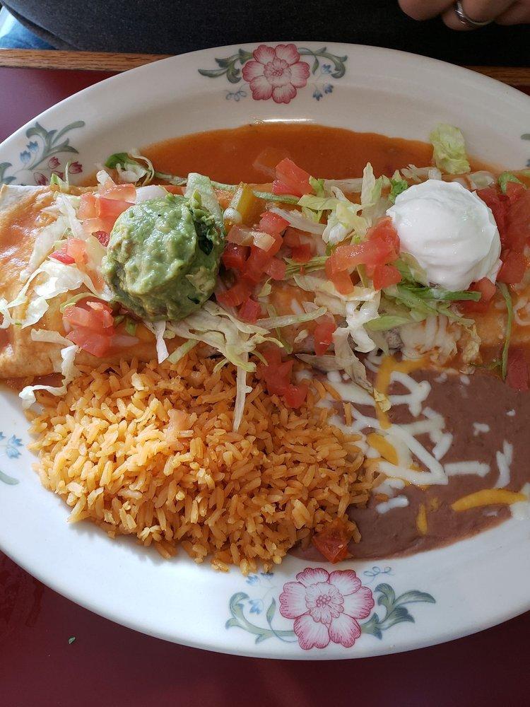Super Burrito · Soft flour tortilla filled with rice, beans, cheese, beef or chicken, covered with Spanish sauce, melted cheese. Garnished with fresh lettuce, tomatoes, guacamole and sour cream.