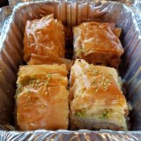 Baklava · Layered filo dough filled with chopped nuts and covered in sweet syrup.