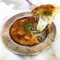 Kunefe · Shredded dough layered with sweet kunefe cheese, baked to a golden color and served with hon...