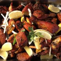 Tandoori Chicken · Bone-in chicken marinated in a yogurt, freshly ground spices and cooked in a tandoor. Served...