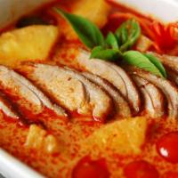 Duck Curry · Roast duck in red curry, coconut milk, pineapple, tomato and basil leaves. Not served with r...