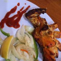Tandoori Chicken · Chicken marinated in Indian spices and yogurt, roasted in tandoor, served with potato dill s...