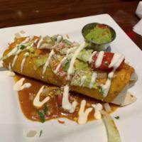 Mexicali Burrito · Choice of shredded chicken, ground beef, pork carnitas or barbacoa. Stuffed with rice and re...