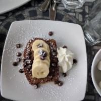 Banana Nut Bread French Toast · Fresh from the bakery banana nut bread made french toast style, topped with banana slices an...