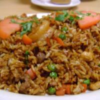 Chaulafan · Asian style fried rice mixed with chicken, shrimp, eggs, beef, pork, green peas and carrots.