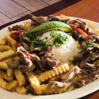 Lomito Saltado · Slices of top round steak sauteed in a home made sauce with peppers, tossed with fries and s...