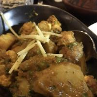 Aloo Gobi · Potato and cauliflower cooked in cumin and spices. Vegan.
