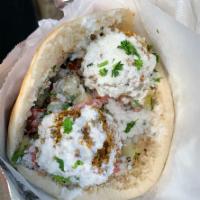 Greek Falafel Sandwich · Served with tomato and cucumber salad and tzatziki sauce. Choice of pita, wrap or baguette.