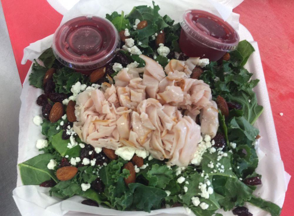 Kale Salad · Kale greens, baby spinach, dried cranberries, sliced roasted almonds, crumbled goat cheese and raspberry vinaigrette dressing.