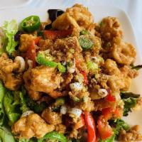 Fried Calamari · Squid seasoned with salt and pepper, tossed with jalapenos, red bell peppers and garlic, ser...