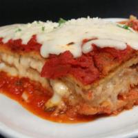 Eggplant Parm · Thin slices of breaded eggplant layered with marinara sauce and mozzarella cheese, side of p...