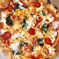 Margherita Pizza · Crushed tomato, fresh mozzarella, cherry tomatoes, garlic, basil and olive oil.