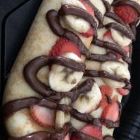 Nutella Crepe · Two crepes stuffed with Nutella, fresh strawberries, banana slices, candied walnuts, drizzle...