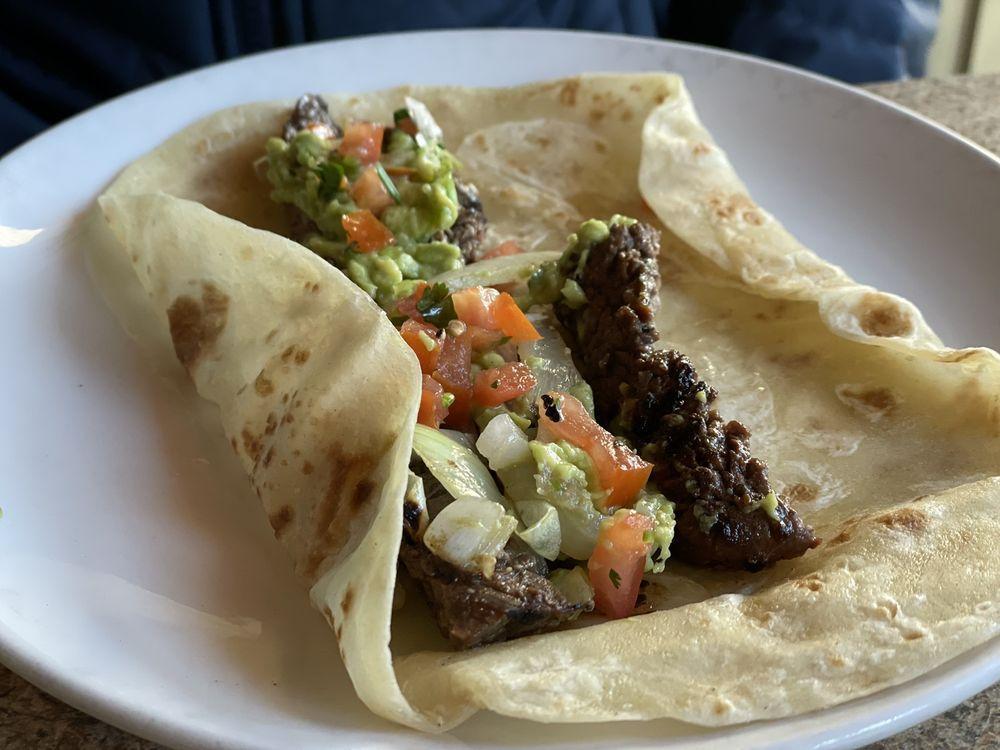 Beef Fajitas Poblano · Topped with sliced poblano peppers, field mushrooms, and melted Monterey jack cheese.  Served with guacamole, pico de gallo, sour cream, cheddar cheese, rice, and your choice of beans.