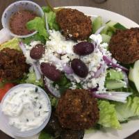 Falafel Greek Salad · An athena Greek salad topped with crispy house-made falafel. Served with tzatziki sauce, our...