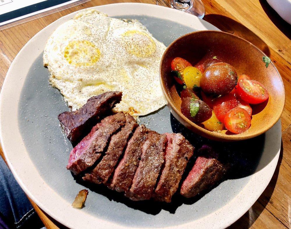 Steak and Eggs · 8 oz. top sirloin steak with 2 eggs and a side of heirloom tomato salad.