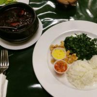 Feijoada · Brazilian black bean stew. Stew of black beans and pork, ribs, smoked sausage served with vi...
