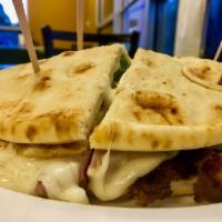 Beirute Sandwich · Pita bread stuffed with sirloin steak, tomatoes, ham, cheese, fried egg, bacon, onions and l...