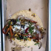 Veggie Taco · Caramelized Onions and Peppers, Corn, Pumpkin Seeds and Black Beans. Topped With Tomatillo S...