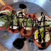 Caprese Salad · Fresh sliced tomatoes, fresh mozzarella and fresh basil with salt and pepper, extra virgin o...