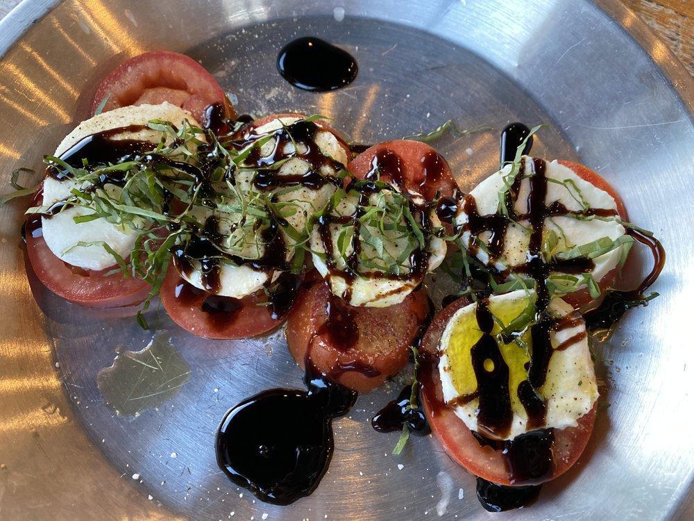 Caprese Salad · Fresh sliced tomatoes, fresh mozzarella and fresh basil with salt and pepper, extra virgin olive oil and balsamic glaze. Gluten free.