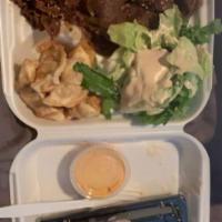 Korean Bulgogi Beef Bento Box · Served with white steamed rice, House ginger salad, Gyoza, a choice of Spring Rolls or  Cali...
